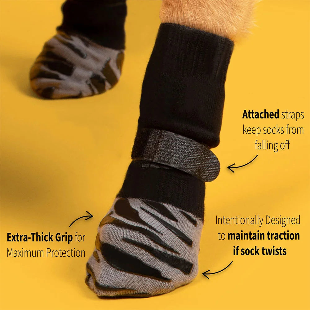A close-up of non-slip dog socks with extra-thick grips and attached straps, demonstrating their traction features.