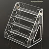 A clear acrylic display stand with multiple slots for holding business cards and brochures.