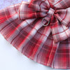 A plaid red and white fabric bow made from pet dress-up harness material for dogs.
