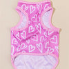 A pink vest patterned with white hearts for a dog or cat.
