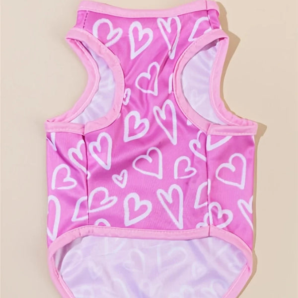 A pink vest patterned with white hearts for a dog or cat.