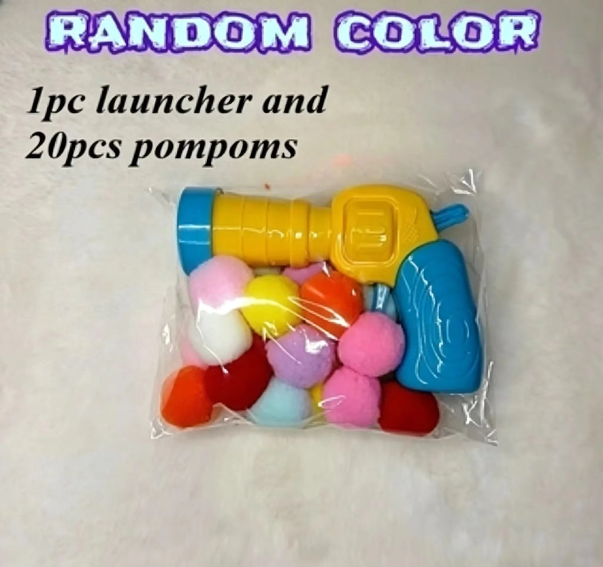 Klare Plastikverpackung mit gelbem Launcher und zwanzig bunter Pompons.