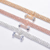 Three strands of crystal rhinestone pet collars featuring bone pendants in gold, rose gold, and silver tones.
