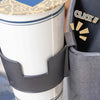 A close-up of a portable vehicle drink holder with a black clamp securing a white cup.