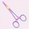 A pair of professional stainless steel pet forceps with iridescent pink and blue coloration.