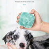 A person is using a soft silicone pet bath brush to massage a dog's fur.