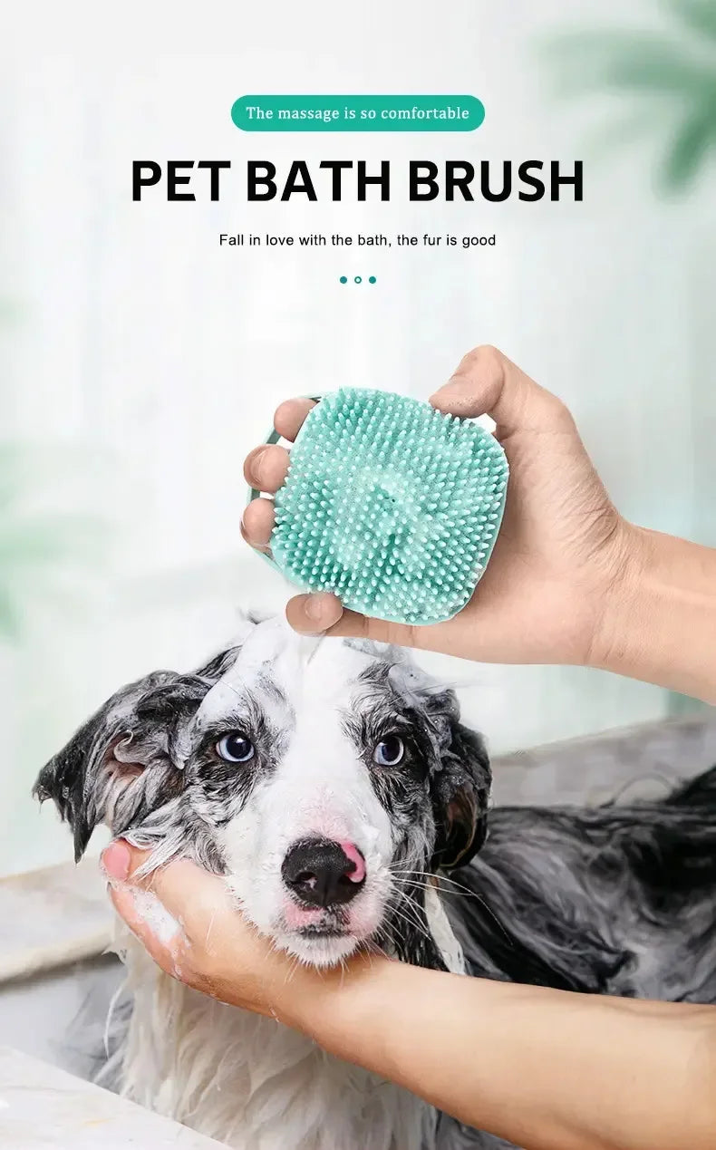 A person is using a soft silicone pet bath brush to massage a dog's fur.