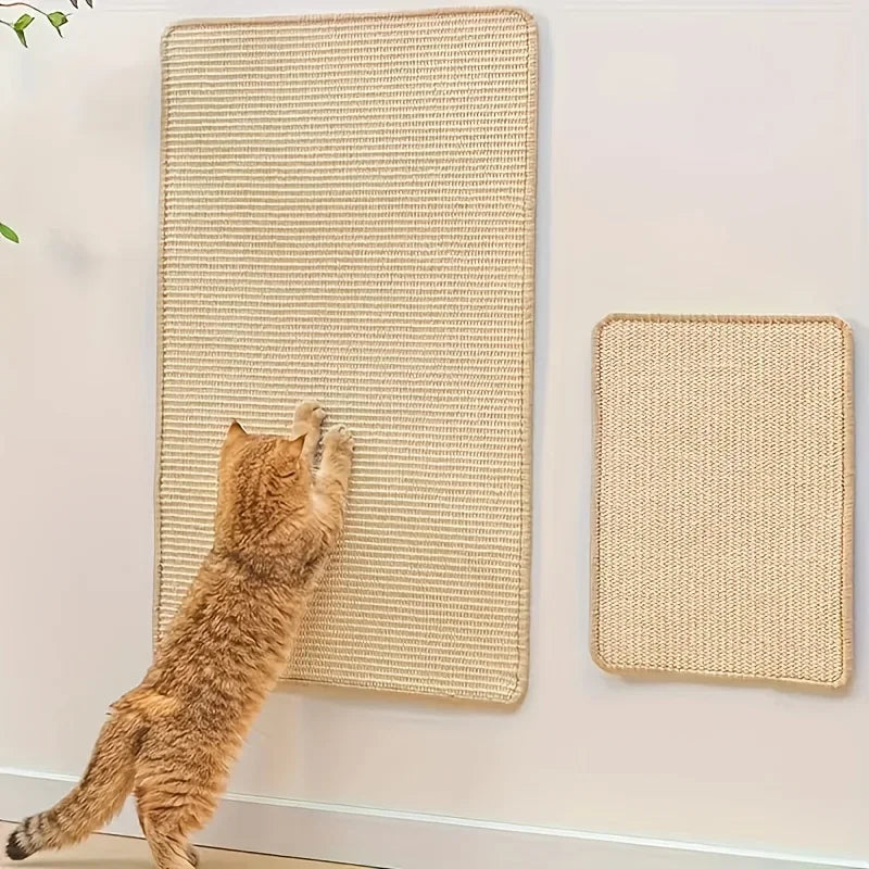 A tabby cat is scratching a woven natural fiber board mounted on a wall, next to another similar scratcher.