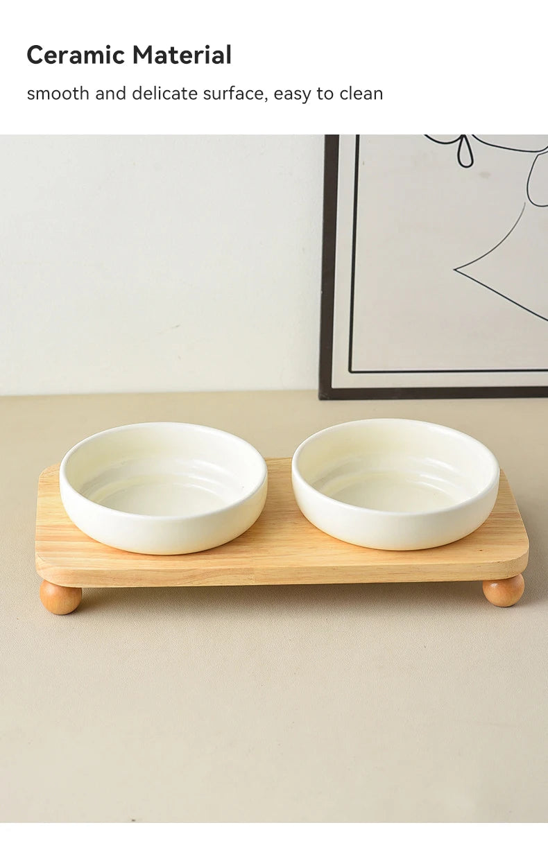 Two white ceramic bowls with a wooden stand for pets