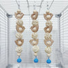 Three decorative wooden parrot swing toys hanging in a clear wire cage