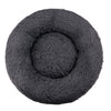 A dark gray plush round pet bed with a textured, soft cover.