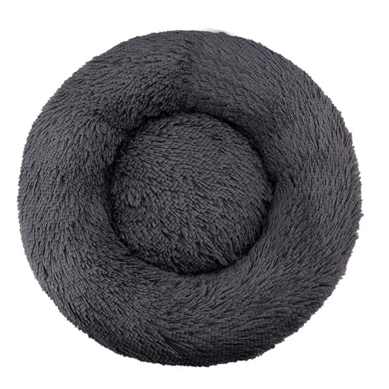 A dark gray plush round pet bed with a textured, soft cover.