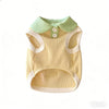 A yellow knitted dog shirt with a light green collar and lapel for a small breed.