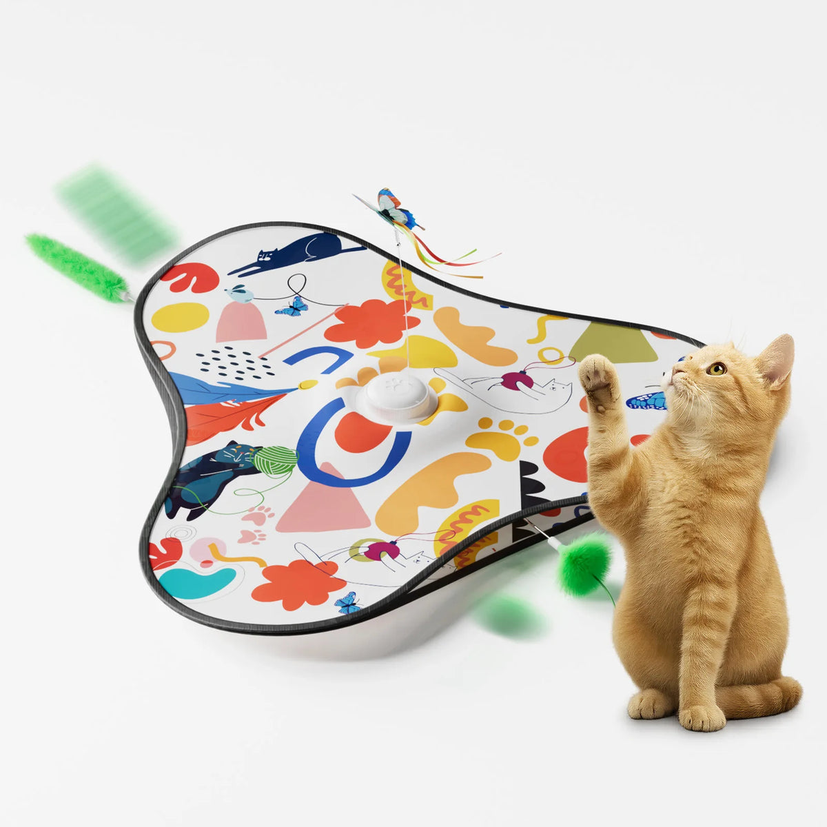 A fluffy orange cat is interacting with an interactive hide and seek toy featuring colorful shapes and a motion-activated fea