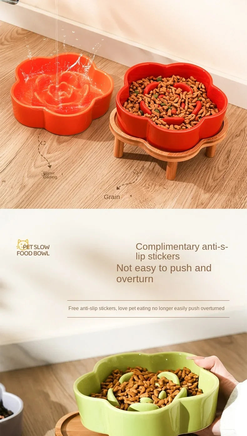 An orange ceramic slow feeder cat bowl with a wooden stand, showing grain being fed into the bowl.