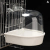 A clear plastic hanging bird bath for parakeets is shown inside a wire cage.