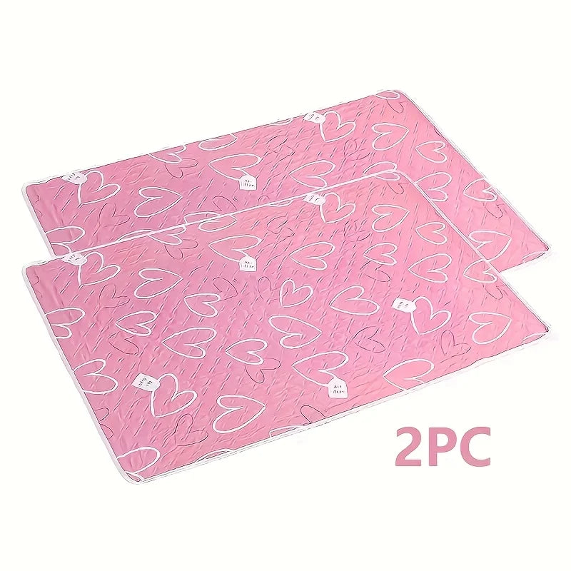 Two pink reusable absorbent pet pee pads stacked together.