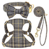 A plaid dog collar, harness, and leash set featuring a bowtie, in black and gold tones.