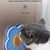 A gray and white cat is licking a blue silicone multi-suction pet licking pad.