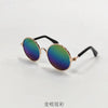 Gold-rimmed vintage round sunglasses with iridescent green and purple lenses