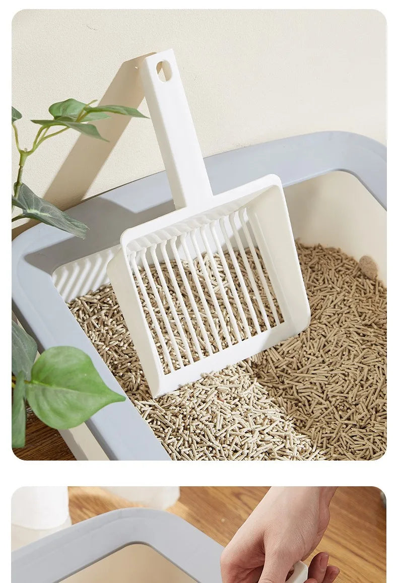 A white extra-large cat litter scoop with a hanging hook is shown scooping dry cat litter in a light blue plastic container.