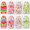 A set of colorful recovery vests for cats featuring various patterns and designs.
