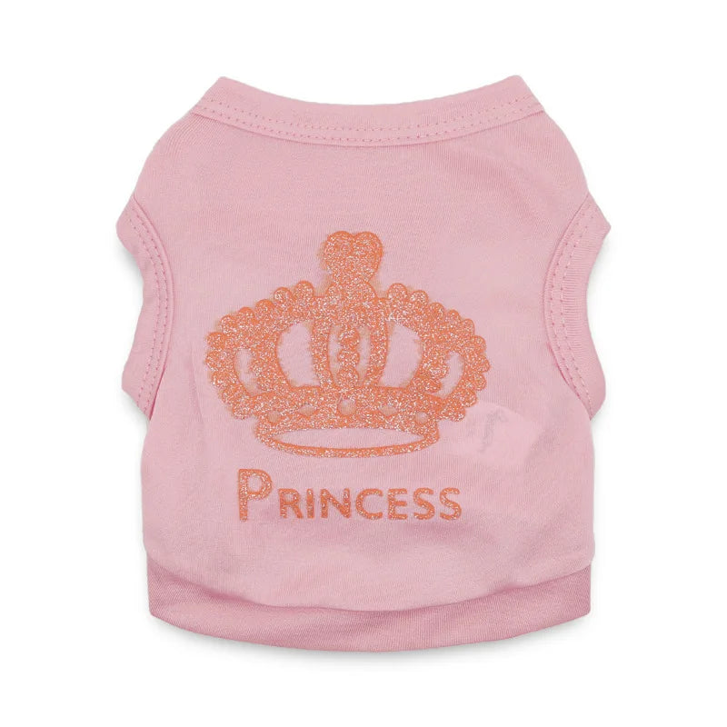 A pink short-sleeved t-shirt for a puppy featuring an orange glitter crown pattern and the word PRINCESS.