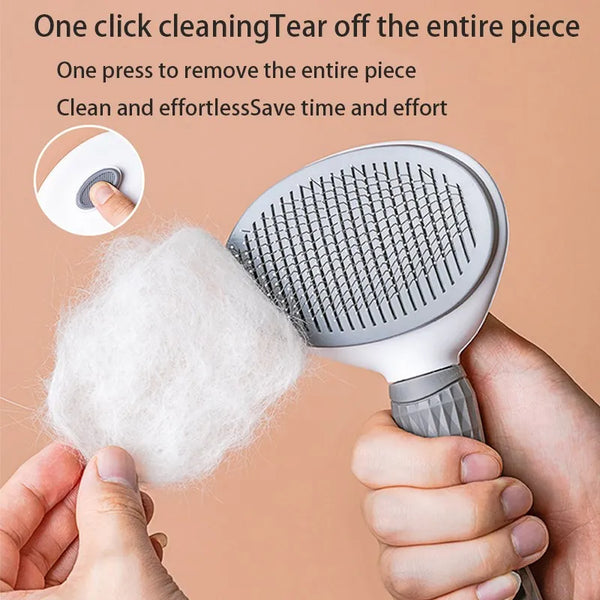 A hand holds a grooming brush with massage pins, demonstrating the one-click cleaning feature for pet hair removal.