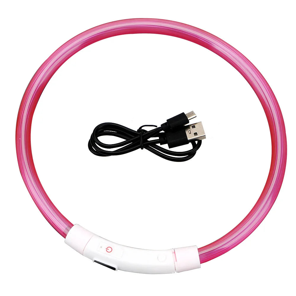 A pink LED dog collar with a white charging base and a black USB cable.