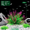 A close-up view of a vibrant pink and green artificial aquatic plant, likely for fish tanks.