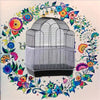 A silver nylon mesh bird cage skirt designed as a debris guard, surrounded by colorful floral and leaf patterns.