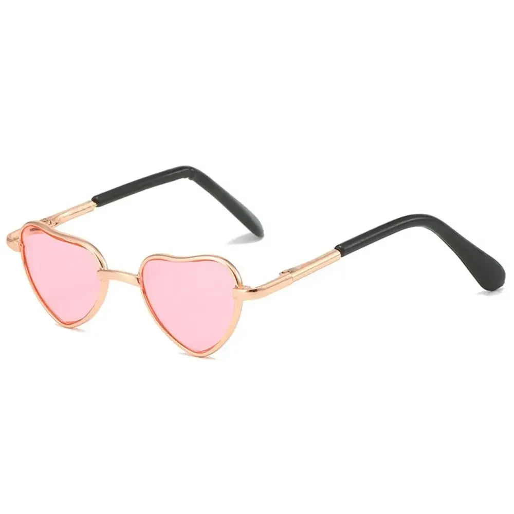 Pink heart-shaped sunglasses with black frames for pets