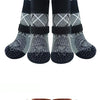 A pack of four anti-slip dog traction socks with a patterned design.