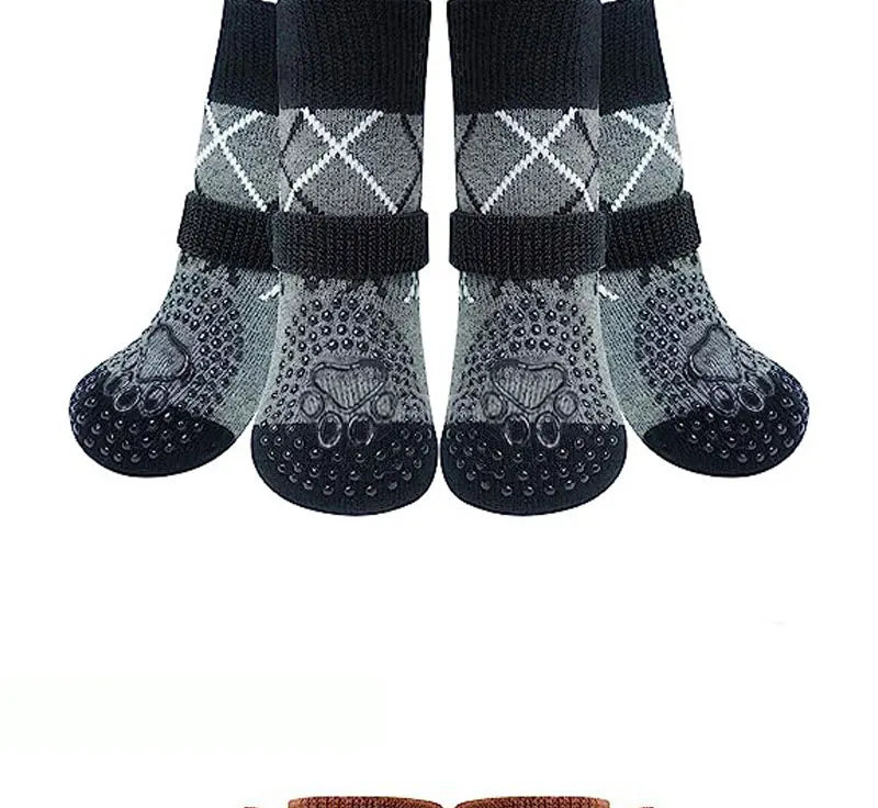 A pack of four anti-slip dog traction socks with a patterned design.