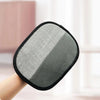 A hand is holding a reusable pet hair remover glove with a double-sided, gray and black mesh surface.