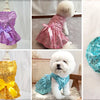 A set of paw print dog waste bags with a dispenser and bow, shown in various colors like teal, purple, pink, and gold.
