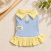 A light blue dress with a yellow collar and ruffled hem, featuring a cute cartoon dog design.