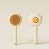 A white pet hair removal slicker brush with a round, textured head and a smooth handle.