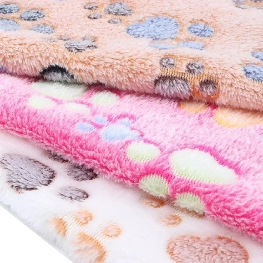 Two pink and white fleece pet bed mat covers with paw print patterns.