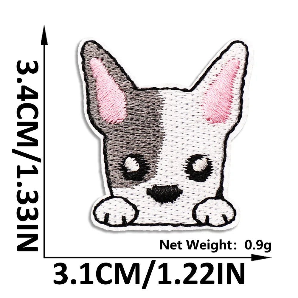 A small, gray and white cat embroidered patch with pink inner ears.