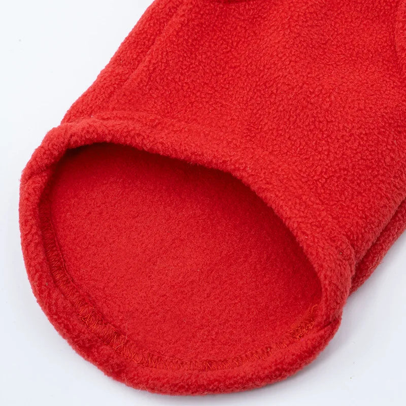 A bright red, fuzzy winter jacket for a dog, shown from the inside view.