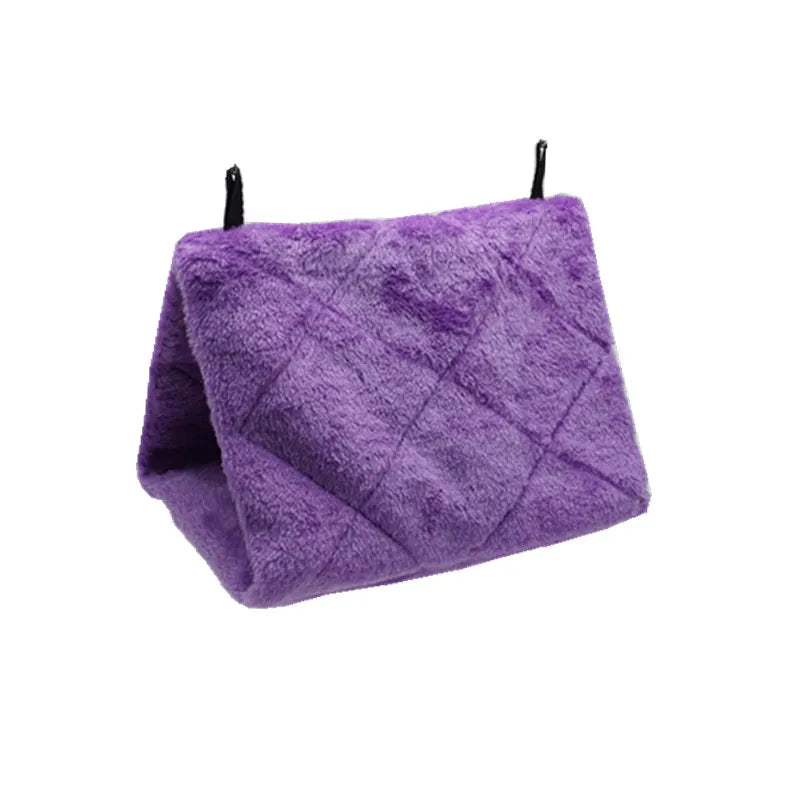 A purple cozy plush bird hammock tent with black hanging strings.