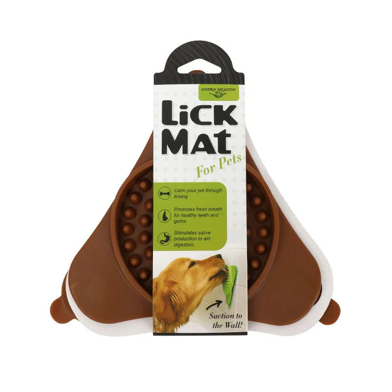 A package of a silicone lick mat for pets with a suction cup is shown on a brown pet bed.