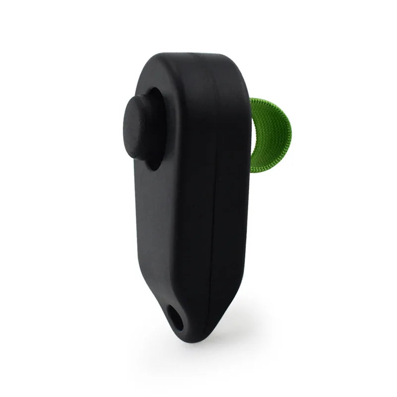 Black pet training clicker with a green rubber button on the side