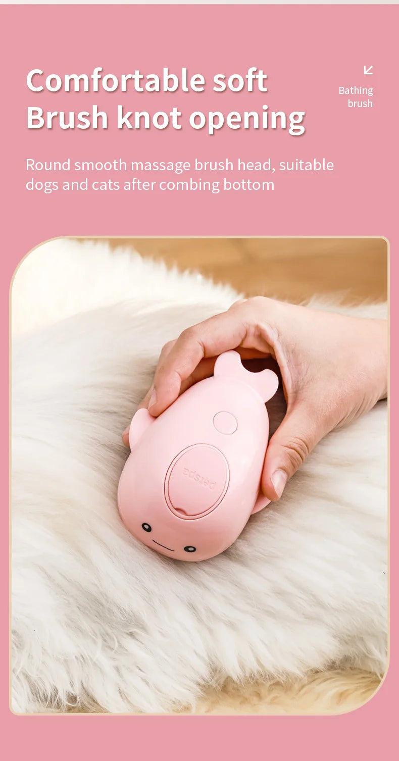 A hand holds a pink electric pet grooming brush with a knot opening on a fluffy white surface.