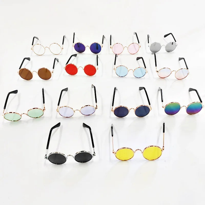 A collection of vintage round pet sunglasses in various colors and styles displayed on a white background.