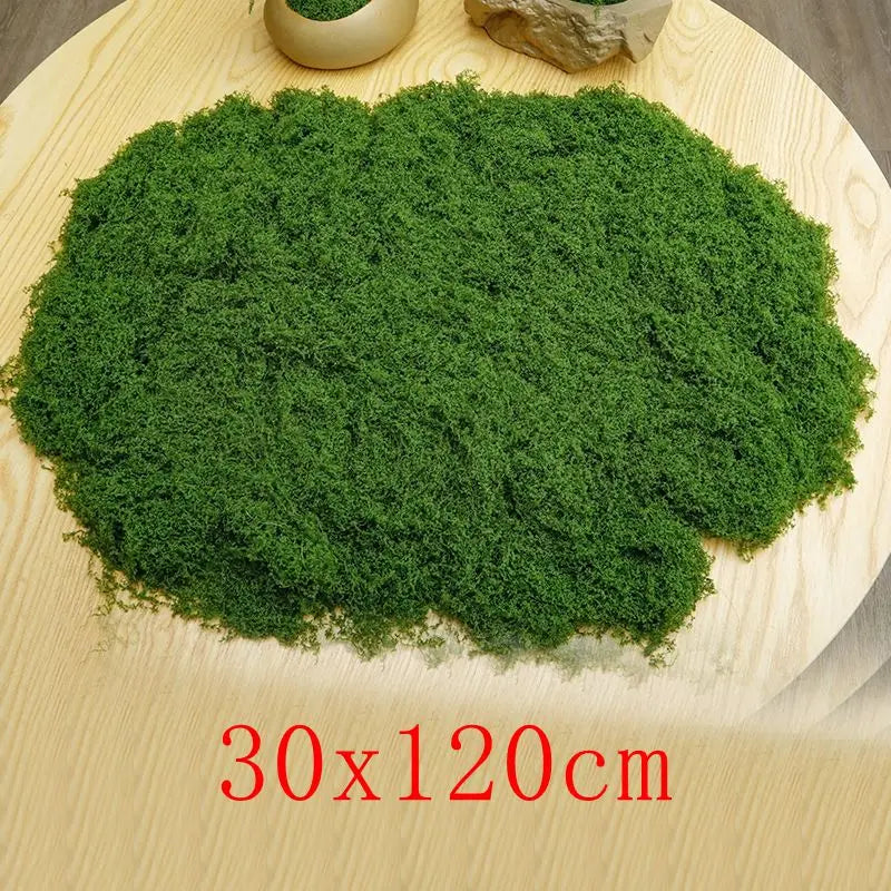 A large quantity of vibrant green preserved moss spread on a light wooden surface.