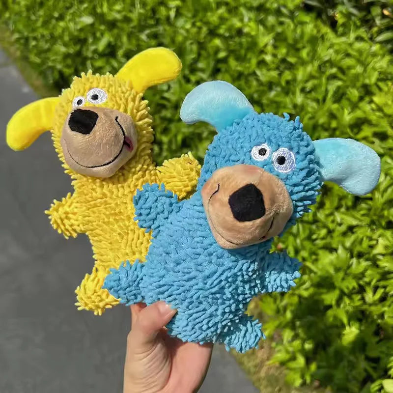 A hand holds a yellow and blue plush squeaky dog toy designed for teething puppies and small dogs.