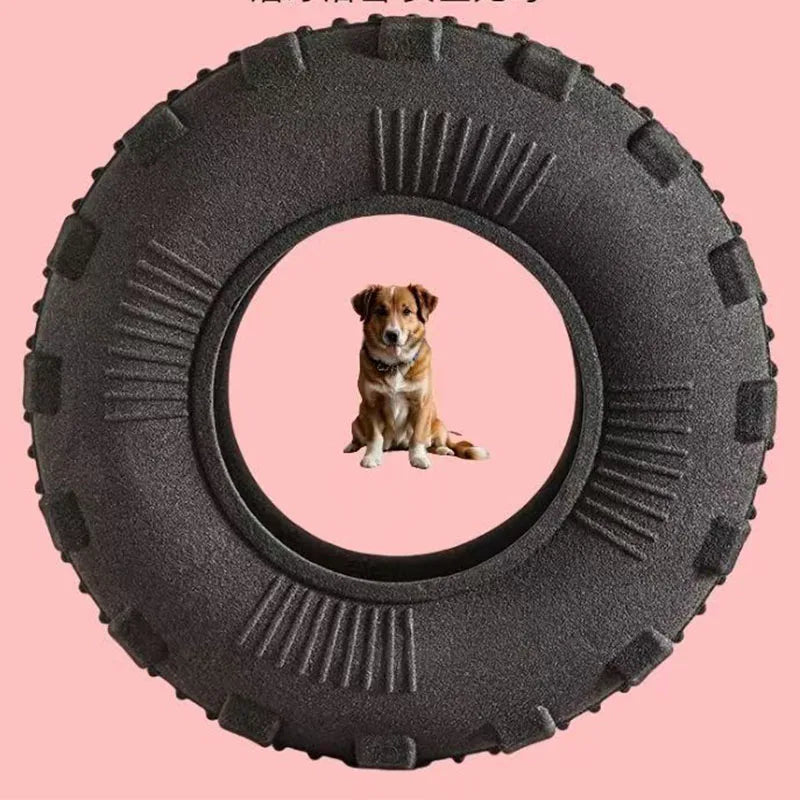 A dark gray rubber chew toy with a circular hole, featuring a small dog sitting inside.