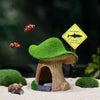 A resin aquarium house decor featuring a tree-like hiding shelter, a small rodent, and a warning sign for sharks.